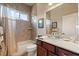 Well-lit bathroom featuring a shower-tub combo, tiled walls, and a vanity with ample counter space at 3375 Bellino Blvd., New Smyrna Beach, FL 32168
