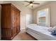 Cozy bedroom with a ceiling fan, window with natural light, and a classic wooden wardrobe at 3375 Bellino Blvd., New Smyrna Beach, FL 32168