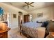Comfortable bedroom features a four-poster bed, hardwood floors, a ceiling fan, and natural light at 3375 Bellino Blvd., New Smyrna Beach, FL 32168