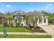 Beautifully landscaped home with lush greenery, palm trees, and a for sale sign on a well-maintained lawn at 3375 Bellino Blvd., New Smyrna Beach, FL 32168