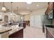 This open kitchen boasts stainless steel appliances, granite countertops, and views of the home's dining and living spaces at 3375 Bellino Blvd., New Smyrna Beach, FL 32168
