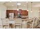 Stylish kitchen with dark wood cabinetry, granite countertops, stainless steel appliances, and barstool seating at 3375 Bellino Blvd., New Smyrna Beach, FL 32168