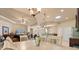Open living space with dining area and kitchen views, featuring comfortable seating and modern lighting fixtures at 3375 Bellino Blvd., New Smyrna Beach, FL 32168