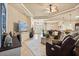Bright and spacious living room with tile flooring, comfortable leather seating, and a view of the entryway at 3375 Bellino Blvd., New Smyrna Beach, FL 32168