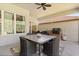 Outdoor patio with a tile-top table, woven chairs, and an outdoor kitchen at 3375 Bellino Blvd., New Smyrna Beach, FL 32168