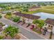 Aerial view of townhomes with lush landscaping and a serene pond at 3462 Allegra Cir, St Cloud, FL 34772