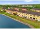 Aerial view of lakeside townhomes with lush surroundings at 3462 Allegra Cir, St Cloud, FL 34772