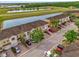 Aerial view of townhomes with beautiful landscaping and water views at 3462 Allegra Cir, St Cloud, FL 34772