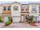 Charming townhome with a brick driveway, attached garage and colorful landscaping at 3462 Allegra Cir, St Cloud, FL 34772