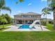 Spacious backyard with a pool, slide, lounge chairs and manicured lawn at 3664 Farm Bell Pl, Lake Mary, FL 32746