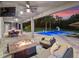 Inviting outdoor living space with a fireplace, dining area, and a view of the pool at 3664 Farm Bell Pl, Lake Mary, FL 32746