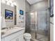 Bathroom featuring a shower with a glass door, toilet, and a vanity with a mirror, sink, and decorative lighting at 3664 Farm Bell Pl, Lake Mary, FL 32746