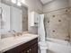 Bathroom featuring a white vanity with an oval sink, toilet, and shower/tub with tiled surround and white shower curtain at 3664 Farm Bell Pl, Lake Mary, FL 32746