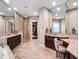 Luxurious bathroom with double sinks, granite counters, tile floors, and a glass enclosed shower stall at 3664 Farm Bell Pl, Lake Mary, FL 32746