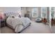 Comfortable bedroom featuring a tufted headboard, soft textures, and plenty of natural light at 3664 Farm Bell Pl, Lake Mary, FL 32746