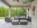 Covered patio with comfortable outdoor seating, ceiling fan, stone pavers, TV, and a view of the green backyard at 3664 Farm Bell Pl, Lake Mary, FL 32746