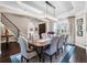 Formal dining room features hardwood floors, a chandelier, tray ceiling, and a view of the staircase at 3664 Farm Bell Pl, Lake Mary, FL 32746
