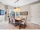 Bright dining room featuring neutral paint, tile floors, a modern light fixture, and a window with backyard views at 3664 Farm Bell Pl, Lake Mary, FL 32746