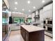 Modern kitchen with a large center island, stainless appliances, and ample counter space at 3664 Farm Bell Pl, Lake Mary, FL 32746