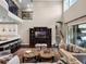 Elegant living room with a soaring ceiling, dark wood floors, a media center, and access to an outdoor area at 3664 Farm Bell Pl, Lake Mary, FL 32746