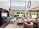 Bright, open living room with high ceilings and large windows overlooking the pool at 3664 Farm Bell Pl, Lake Mary, FL 32746