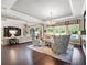 Open-concept living room with hardwood floors and a view of the backyard pool area at 3664 Farm Bell Pl, Lake Mary, FL 32746