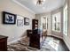 Cozy office with a large desk, patterned rug, and windows with natural light, ideal for remote work or study at 3664 Farm Bell Pl, Lake Mary, FL 32746