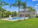 Backyard oasis features a sparkling pool, lush landscaping, and a spacious patio perfect for outdoor entertaining at 3664 Farm Bell Pl, Lake Mary, FL 32746