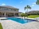 Beautiful pool with slide and lounge chairs, set in a backyard with a covered patio and lush landscaping at 3664 Farm Bell Pl, Lake Mary, FL 32746