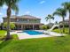 Stunning home backyard features a sparkling pool, water slide, covered patio, and lush green lawn at 3664 Farm Bell Pl, Lake Mary, FL 32746
