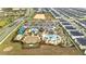 Aerial view of community with pools, water park, clubhouse, mini golf and many homes at 368 Ocean Course Ave, Davenport, FL 33896