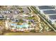 Aerial view of a community pool, mini golf, clubhouse, and ample seating, perfect for socializing at 368 Ocean Course Ave, Davenport, FL 33896