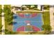 Aerial image of community basketball court surrounded by trees, with benches and pathways at 368 Ocean Course Ave, Davenport, FL 33896
