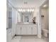 Bright bathroom with double vanity, full mirror, tiled floors, and separate toilet room at 368 Ocean Course Ave, Davenport, FL 33896