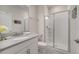 Bright bathroom featuring a glass shower, neutral tile, and a sleek vanity with gray countertop at 368 Ocean Course Ave, Davenport, FL 33896