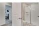 Bright bathroom featuring glass-enclosed shower and a door to the bedroom at 368 Ocean Course Ave, Davenport, FL 33896