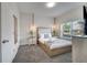Cozy bedroom featuring a comfortable bed, soft carpet, and a bright window with outside views at 368 Ocean Course Ave, Davenport, FL 33896