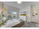 Bright bedroom with a cozy bed, a dresser with a television, and a sun-filled window at 368 Ocean Course Ave, Davenport, FL 33896