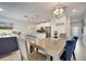Open concept dining area showcasing a modern table with views into the living room and kitchen at 368 Ocean Course Ave, Davenport, FL 33896
