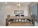 Modern dining room features a long wooden table with bench seating, with lots of light at 368 Ocean Course Ave, Davenport, FL 33896