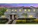 Charming townhome with a modern facade, red door, covered entry, and professionally landscaped front yard at 368 Ocean Course Ave, Davenport, FL 33896