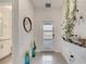 Bright foyer with tile floors, a decorative mirror, a white door, and a green hanging plant at 368 Ocean Course Ave, Davenport, FL 33896