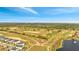 Beautiful aerial view of the community golf course and lake near homes at 368 Ocean Course Ave, Davenport, FL 33896