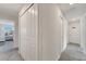 Hallway featuring a carpet and providing access to multiple rooms, including a bedroom with natural light at 368 Ocean Course Ave, Davenport, FL 33896