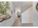 Bright hallway featuring modern tile flooring, decorative accents and an open view of the dining area at 368 Ocean Course Ave, Davenport, FL 33896