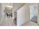 Hallway with tiled floors leads to a dining area and carpeted stairs at 368 Ocean Course Ave, Davenport, FL 33896