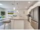 Modern kitchen featuring stainless steel appliances, a gray countertop, and an eat-in island at 368 Ocean Course Ave, Davenport, FL 33896