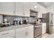 Well-equipped kitchen with stainless steel appliances, sleek cabinetry, and a stylish subway tile backsplash at 368 Ocean Course Ave, Davenport, FL 33896