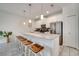 Spacious kitchen with barstool seating and stainless steel appliances at 368 Ocean Course Ave, Davenport, FL 33896