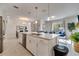 Open-concept kitchen features a large island, modern appliances, and seamless flow into the living space at 368 Ocean Course Ave, Davenport, FL 33896